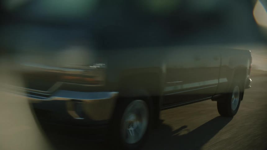 Dark modern pickup truck drives on highway