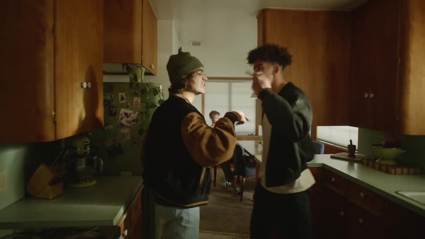 A view of two people fighting and yelling in a kitchen