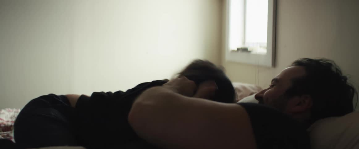 Father and child play and laugh in bedroom