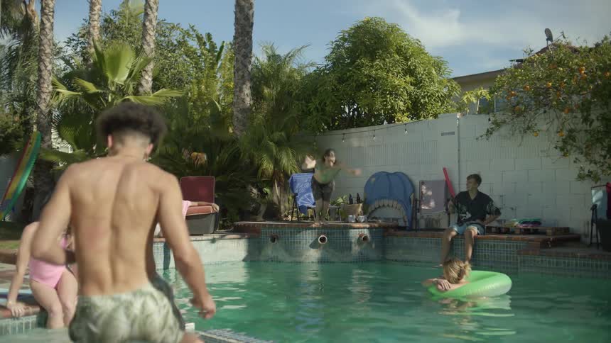 Group of friends having fun in the pool on the backyard at summer
