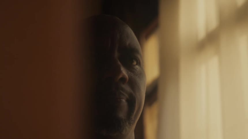 A man next to a window at home