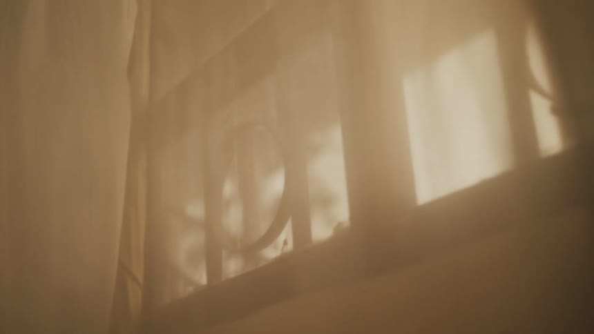 Drapes blowing over a window in a home