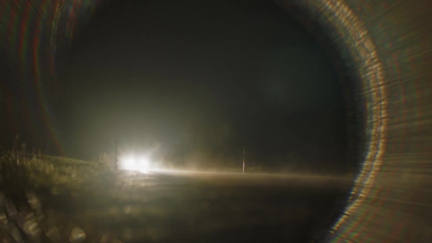 A car passes on the dark road