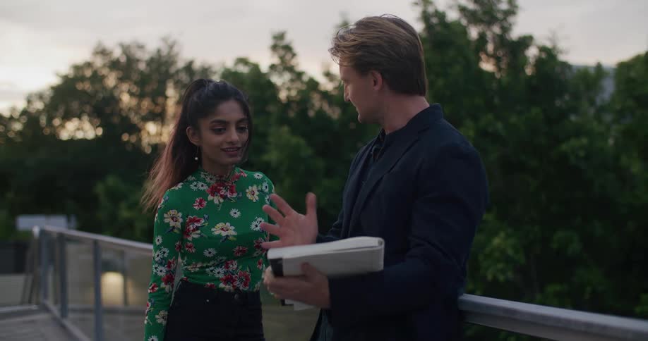 A man and woman talking together outside