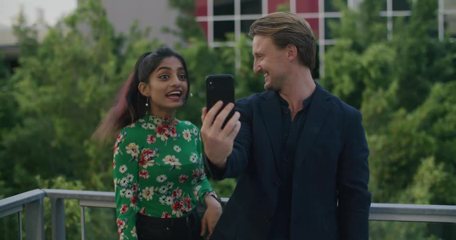 Male and female talking to phone