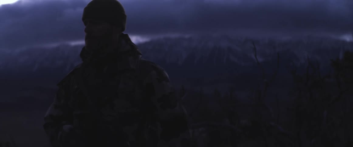 A portrait of a man in the wilderness at night
