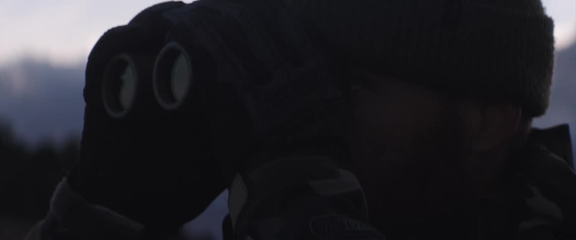 Man looking through binoculars