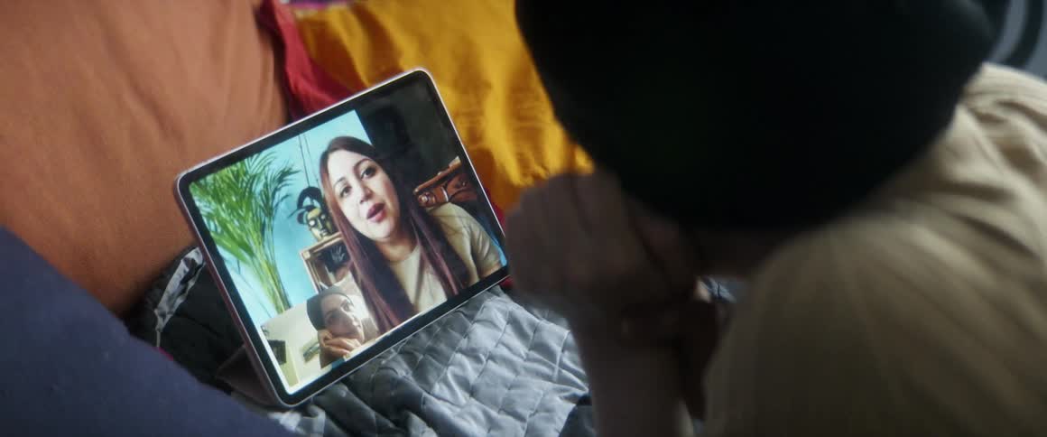 Two girls have a digital conversation on a tablet