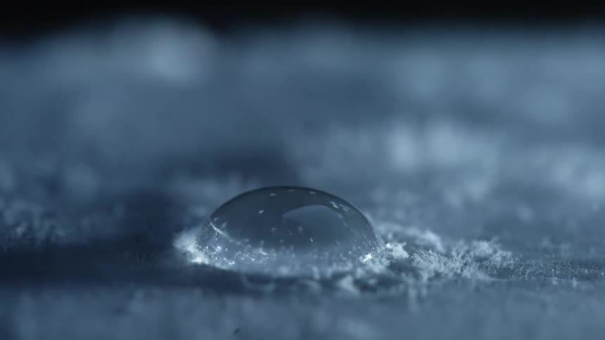 The drop of water freezes over