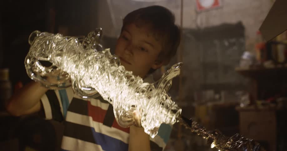 Boy puts together craft in workshop