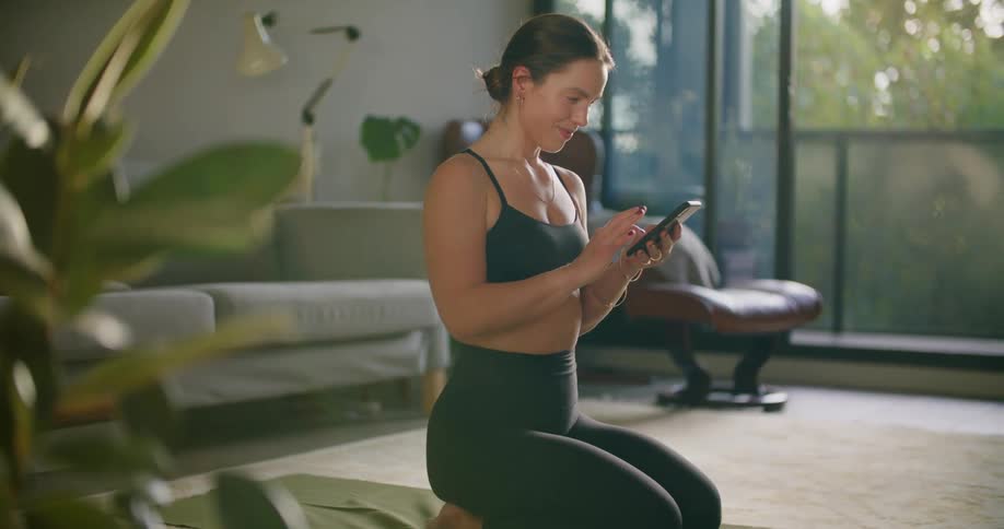A woman typing on a smartphone