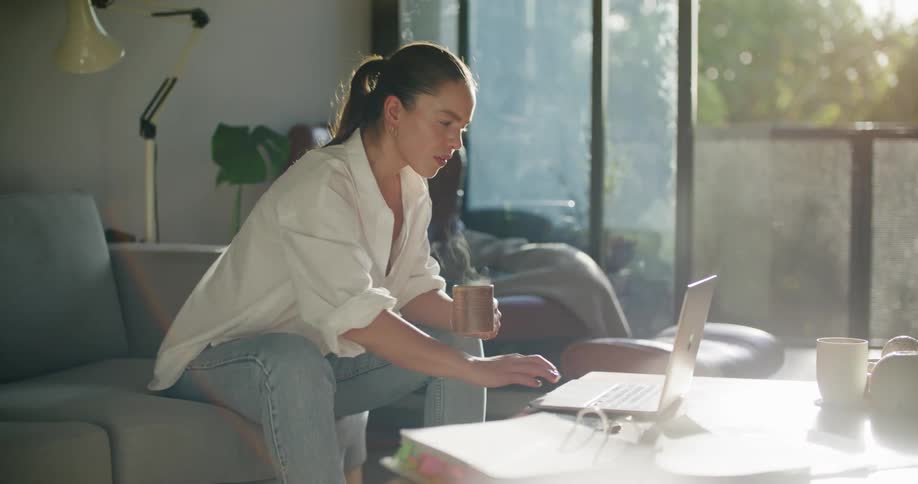 A woman typing on a laptop