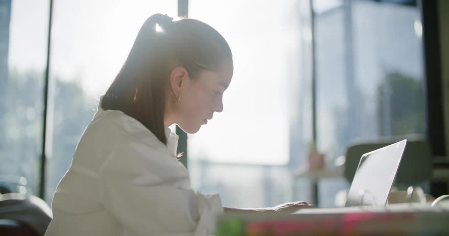 A woman typing on a laptop