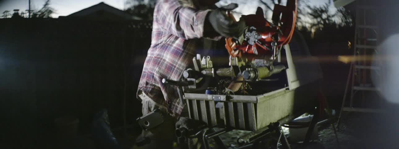 A man cutting things on a saw at a job site