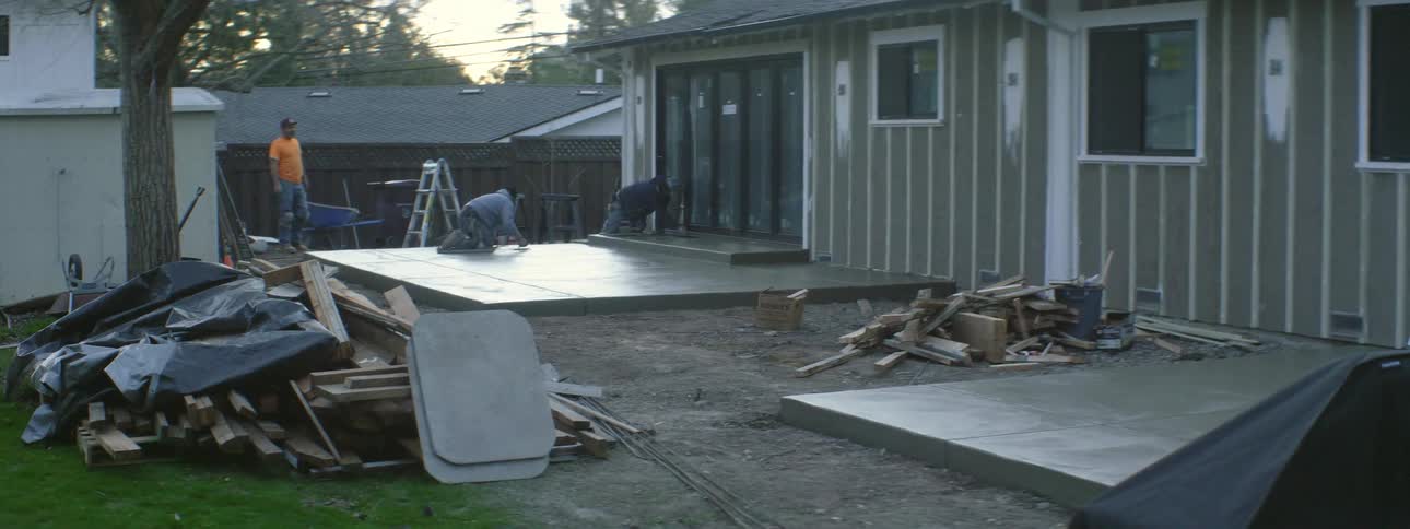 Men are working on a home in the yard