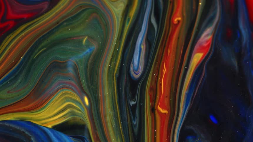 Primary colors combine to form swirl patterns on a smooth surface