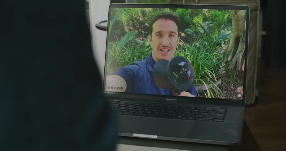 Two people are video chatting on a laptop
