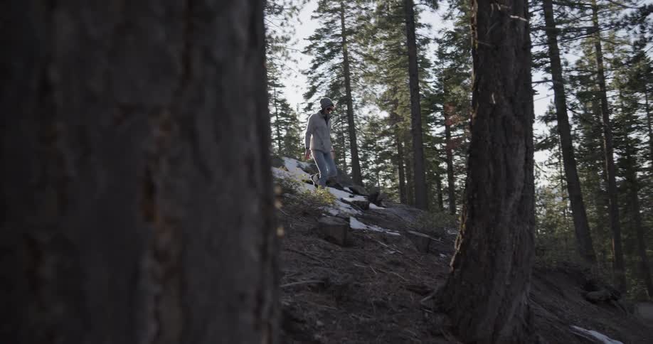 A woman is hiking downhill