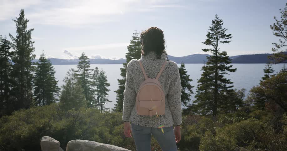 A woman is hiking outdoors in spring