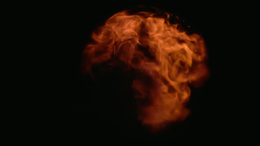 Orange flames dissipating inside a glass ball on a black background