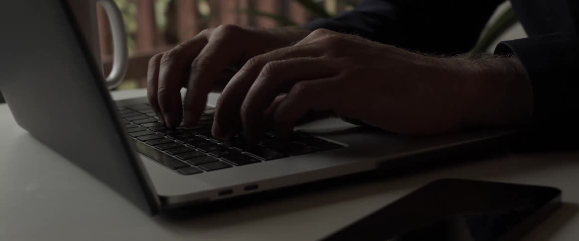 A person is typing on a laptop computer