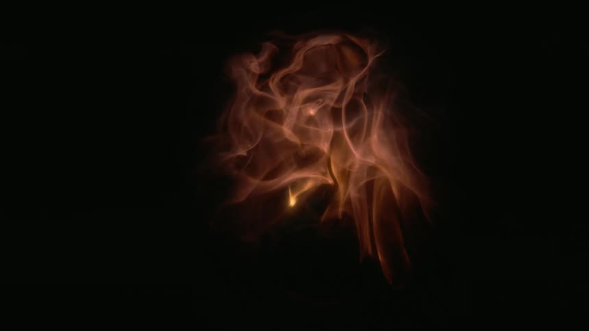 Orange flames dissipating inside a glass ball on a black background