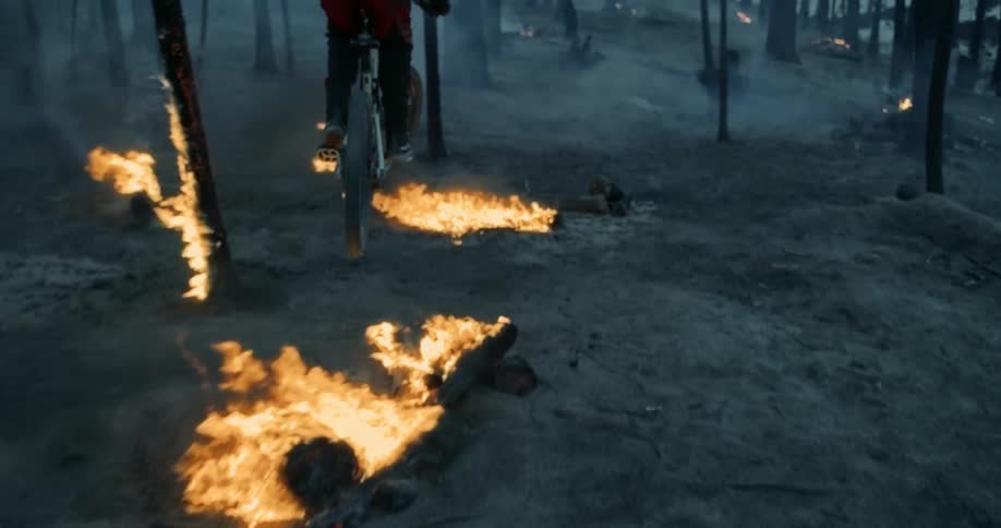 Man biking in forest on fire
