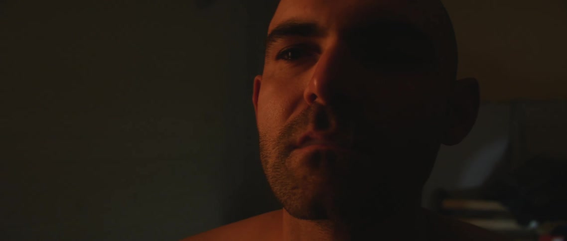 A man smoking a cigarette in the dark