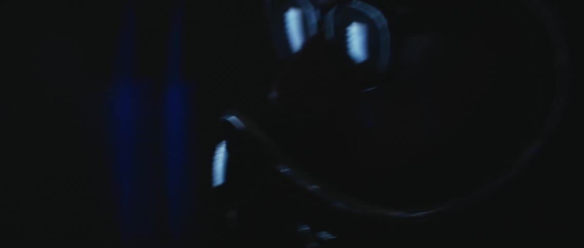 Close up of a man with sunglasses wearing a crash helmet at night