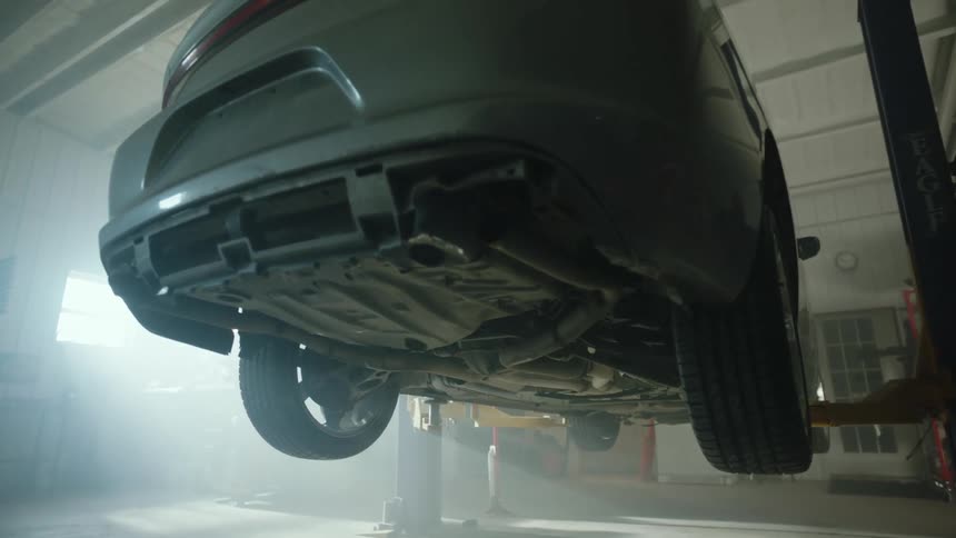 A car is being worked on in a shop