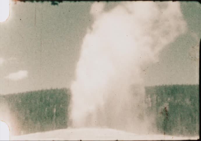 The Old Faithful geyser erupts in Yellowstone National Park in the 1960's