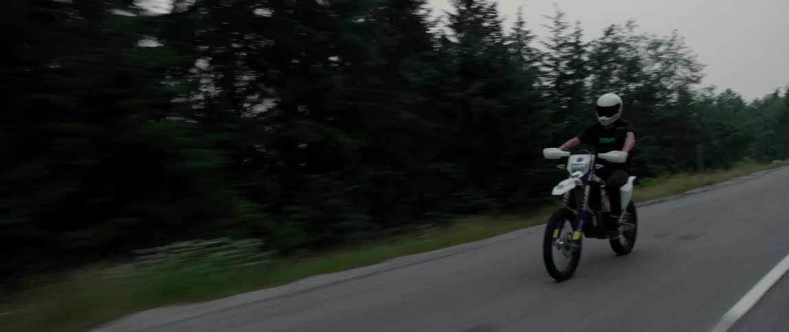 A person is riding a motorcycle on a road