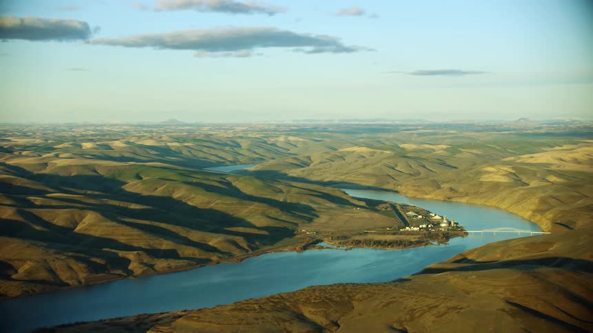 Central Ferry Bridge also known as Elmer C. Huntley Bridge spanning the Lower Snake River in Eastern Washington State at sunset in this sweeping aerial