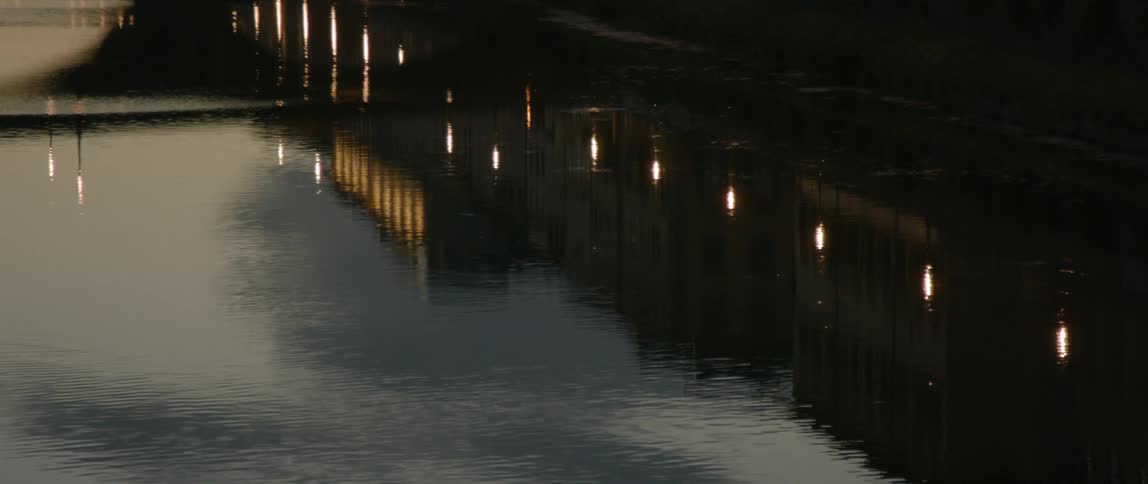 Lights and building are reflected in water
