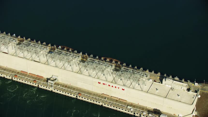 Tight aerial look down shot of Ice harbor Dam on the Lower Snake River in Eastern Washington in afternoon sunlight