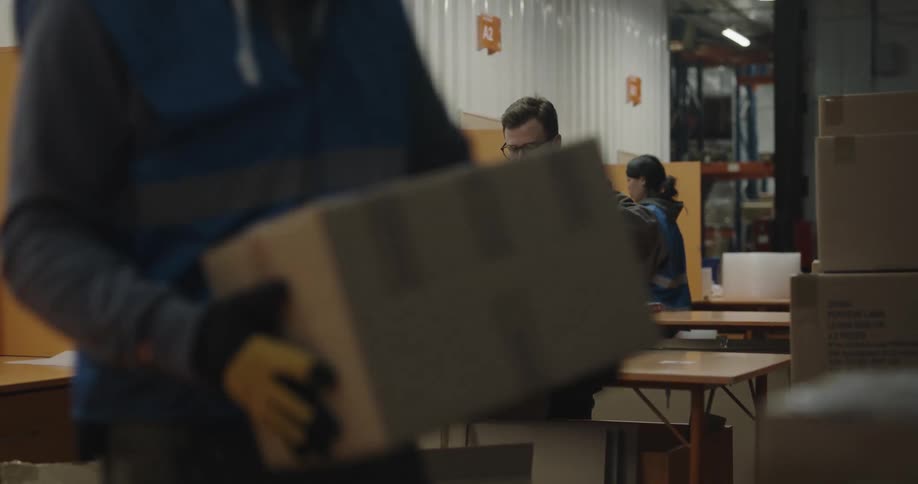 Workers boxing items in a warehouse