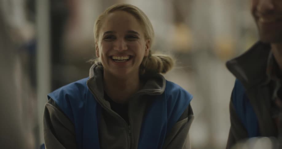 Group of coworkers talking and laughing at break time in the warehouse