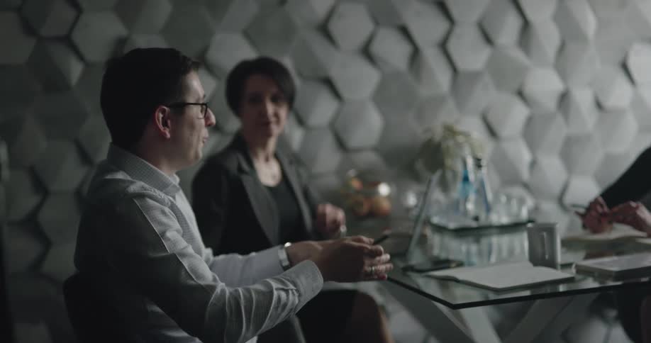 A group of people talking at a desk