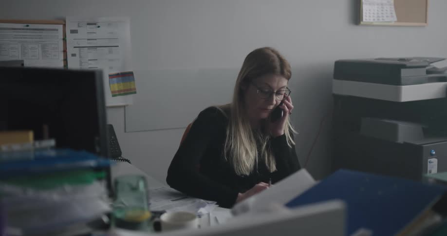 Woman on the phone scheduling an appointment at the office