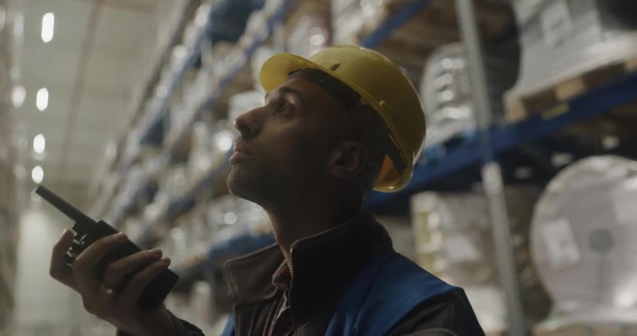 Warehouse worker talking on radio