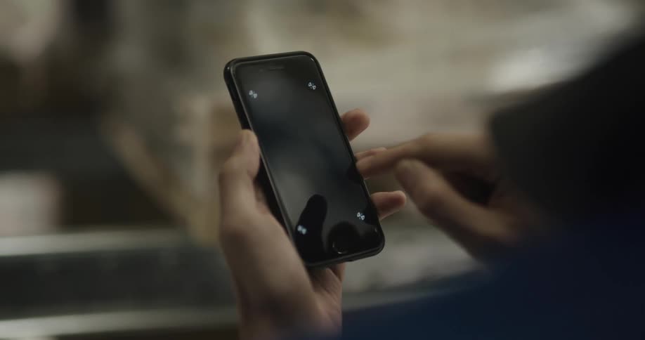 A person touching the screen of a smartphone with a replaceable screen