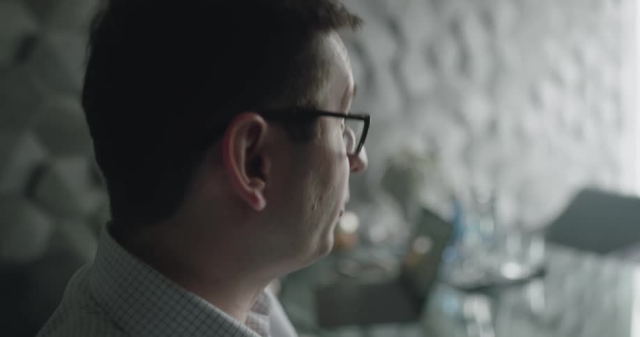 A man talks as a woman uses a laptop