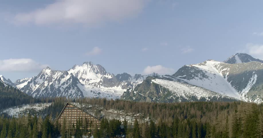 A building sits in front of a large mountain range