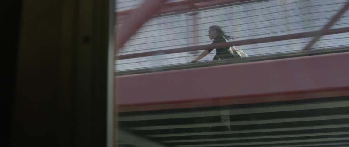 A woman is riding her bike on a bridge