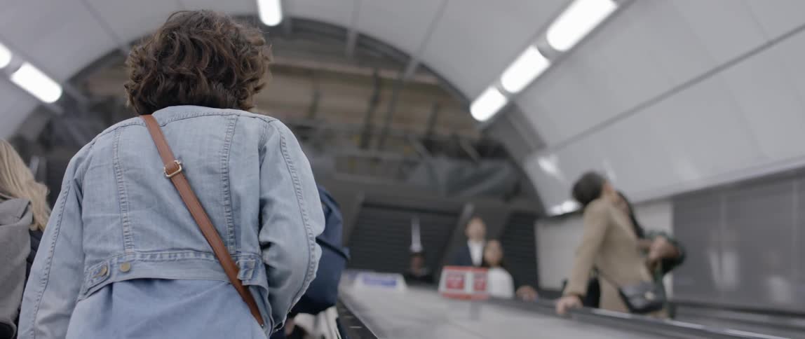 People riding escalators