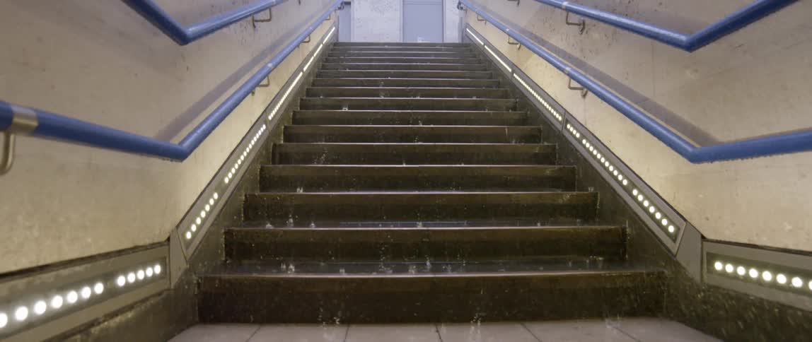 Rain is coming down hard upon a flight of stairs