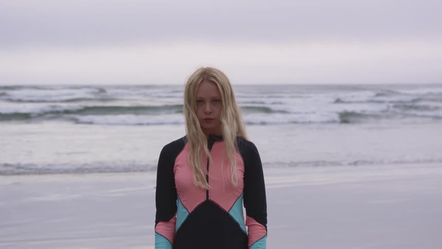 A portrait of a woman standing at the beach