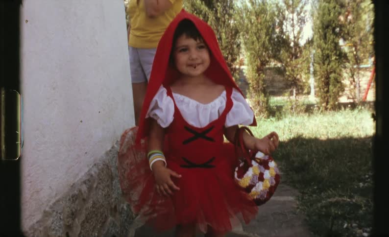 A child is dressed up for halloween outside