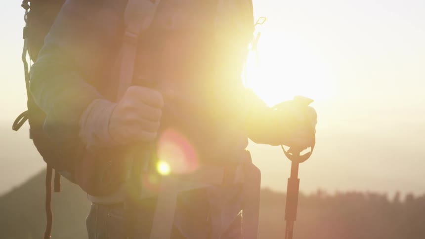 A man out hiking stands and looks around