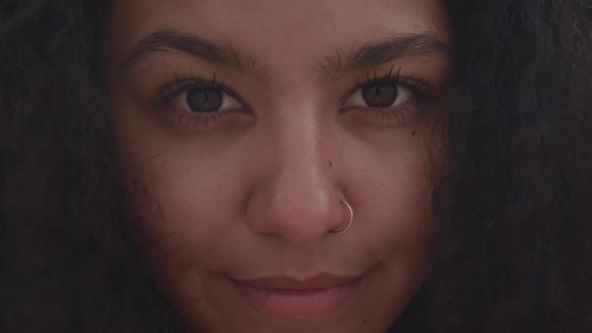 A woman with a nose ring staring